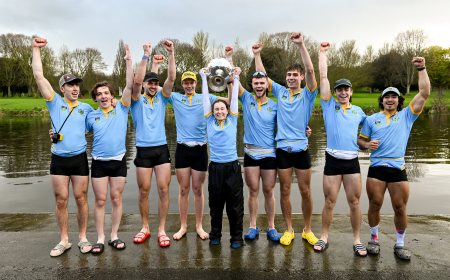 Men's Boat Club members lift the Colours trophy post race